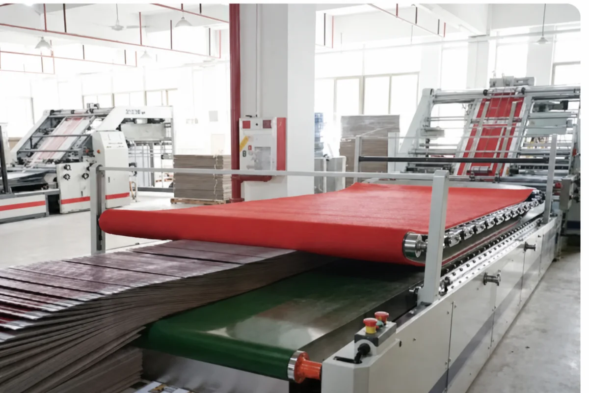 Printed sheets moving through a corrugated board lamination line